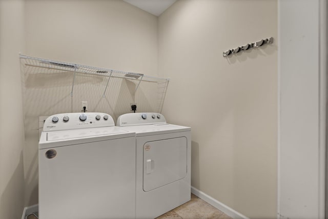 clothes washing area featuring independent washer and dryer and light tile patterned floors