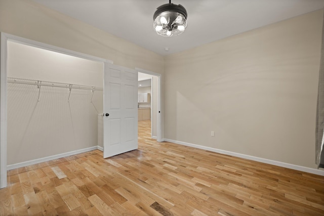 unfurnished bedroom with a closet and light hardwood / wood-style flooring