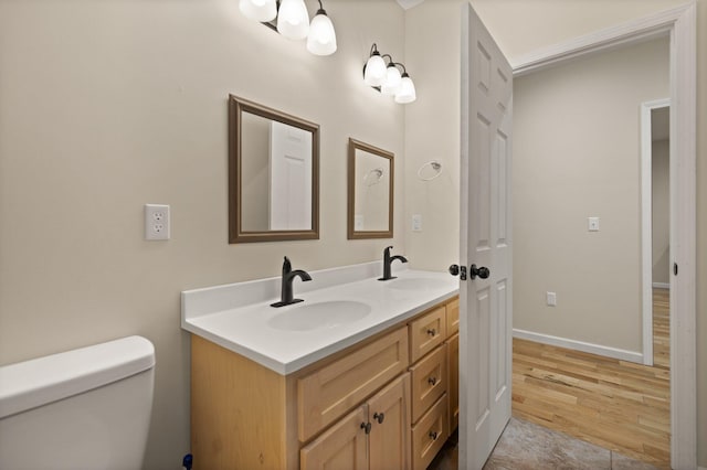 bathroom featuring hardwood / wood-style floors, vanity, and toilet