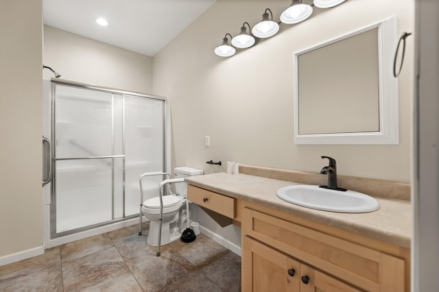 bathroom with vanity, toilet, and a shower with door