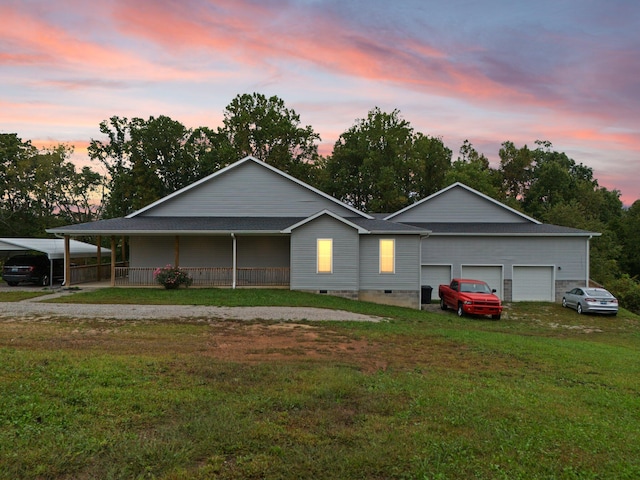 view of front of house featuring a yard, a porch, and a garage