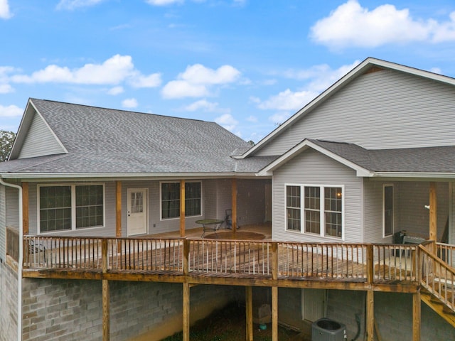 rear view of house with central AC unit and a deck