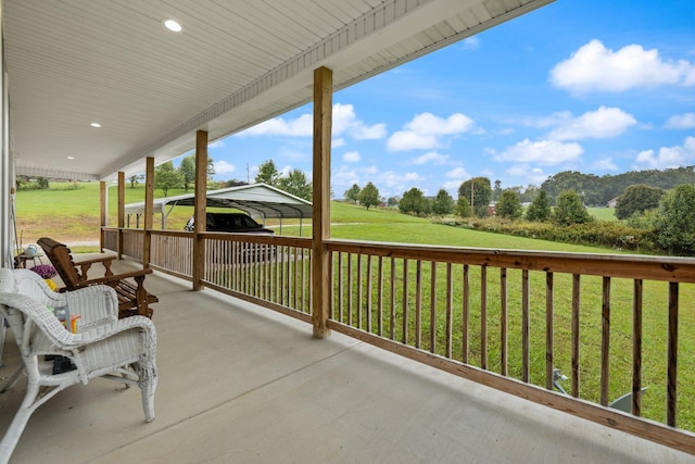 view of patio with a carport and a porch