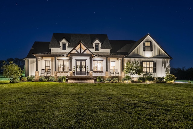 view of front of property featuring a lawn and a porch