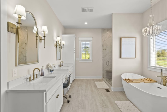 bathroom with vanity, hardwood / wood-style flooring, and separate shower and tub