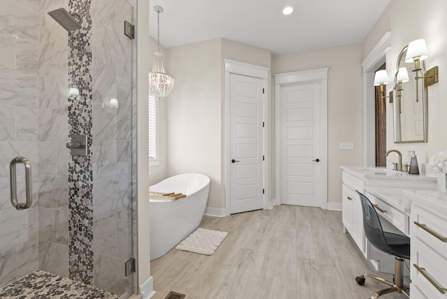 bathroom with vanity, hardwood / wood-style flooring, and plus walk in shower