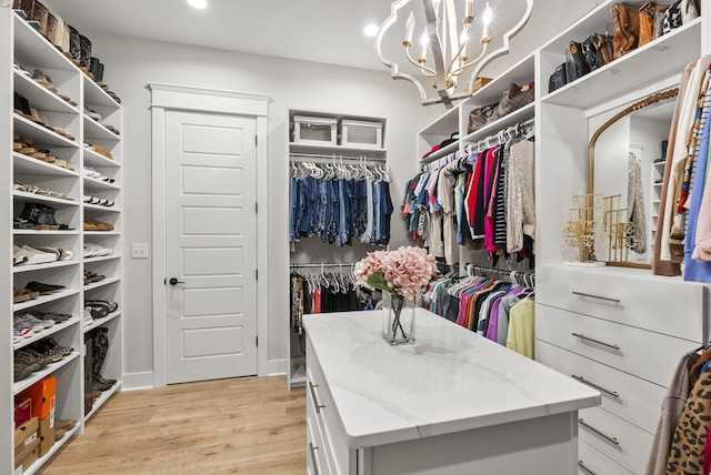 walk in closet featuring light hardwood / wood-style flooring