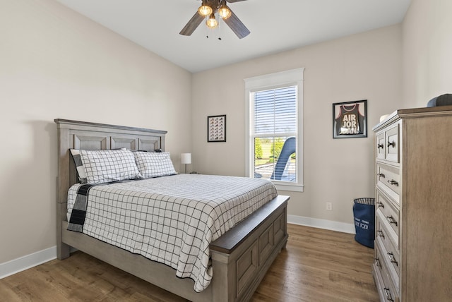 bedroom with wood-type flooring and ceiling fan