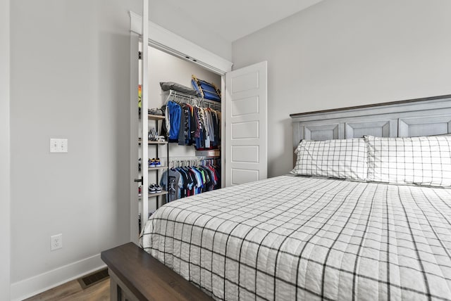 bedroom with wood-type flooring and a closet