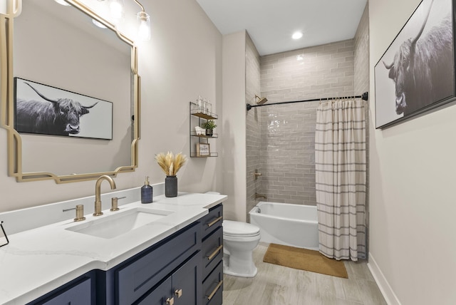 full bathroom with vanity, toilet, wood-type flooring, and shower / tub combo