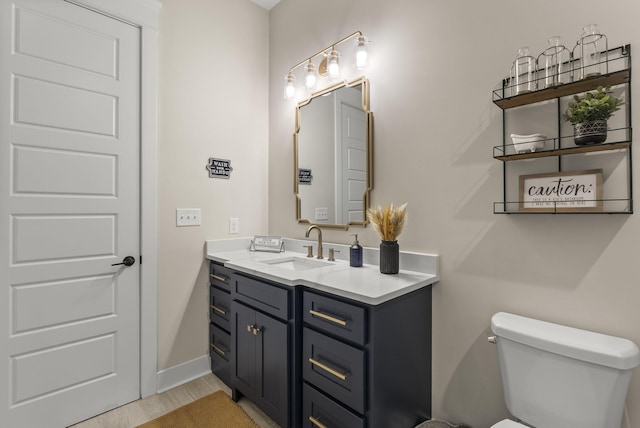 bathroom with toilet and vanity