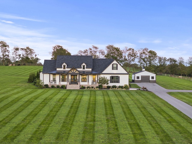 view of front of home with a front yard, covered porch, and a garage