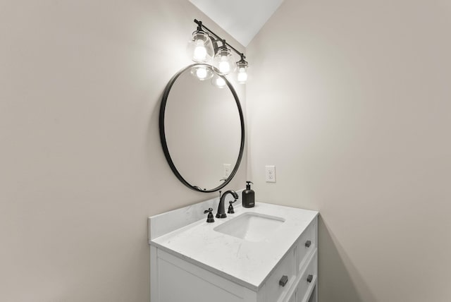 bathroom with vanity and lofted ceiling