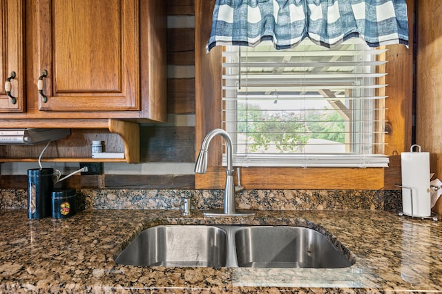 kitchen featuring dark stone counters and sink