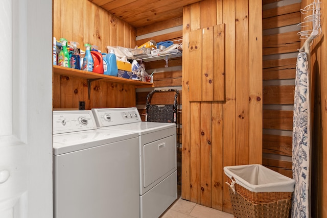 laundry area with light tile patterned floors, wood ceiling, wooden walls, and independent washer and dryer