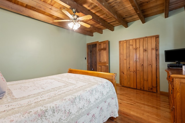 bedroom with ceiling fan, beamed ceiling, hardwood / wood-style floors, and wooden ceiling