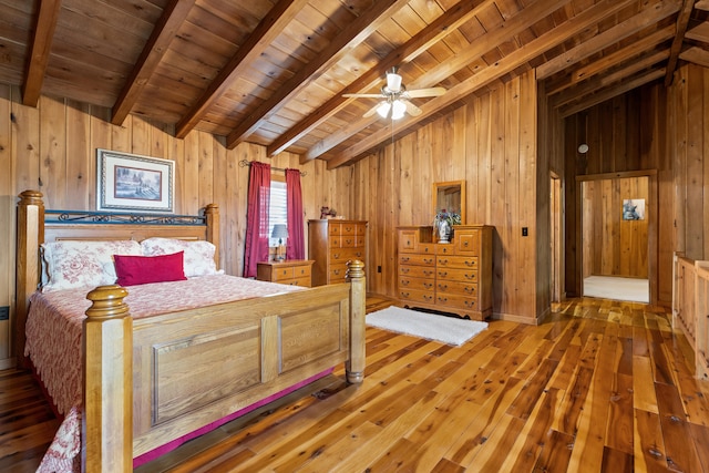 bedroom with wooden ceiling, wooden walls, dark hardwood / wood-style flooring, and lofted ceiling with beams