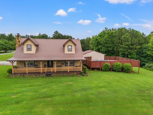 rear view of property featuring a lawn and a wooden deck