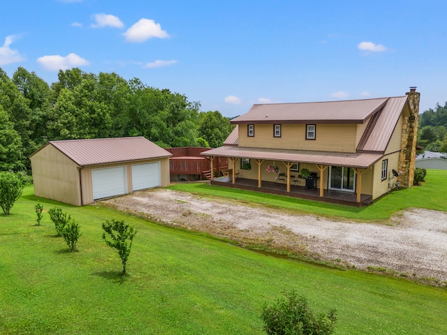 back of property featuring an outdoor structure, a garage, a porch, and a lawn