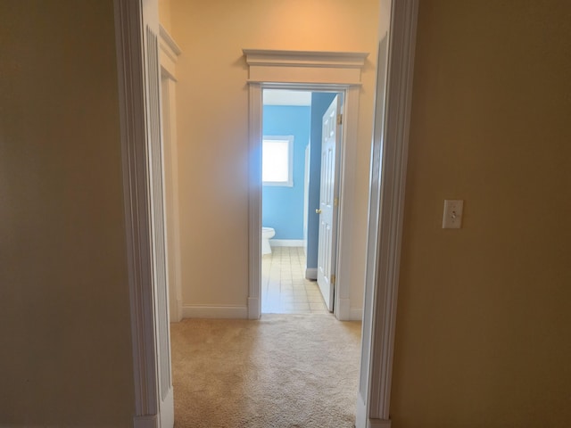 corridor featuring light colored carpet