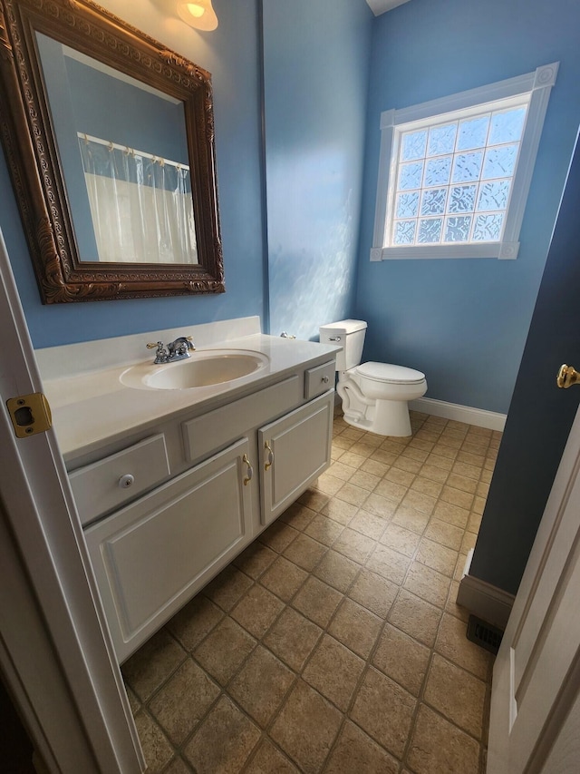 bathroom featuring vanity and toilet