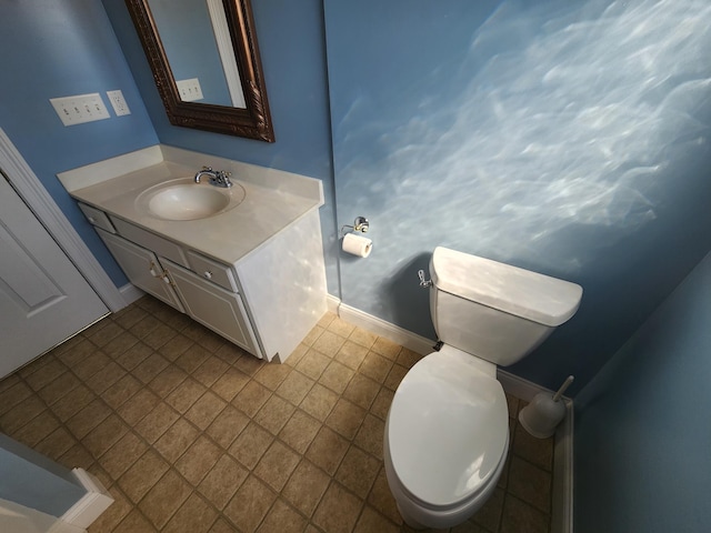 bathroom with vanity, tile patterned flooring, and toilet