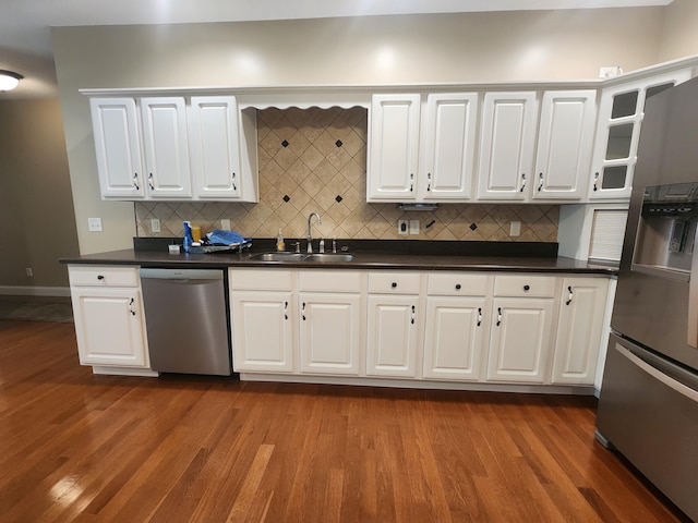 kitchen featuring hardwood / wood-style floors, sink, stainless steel appliances, and white cabinets