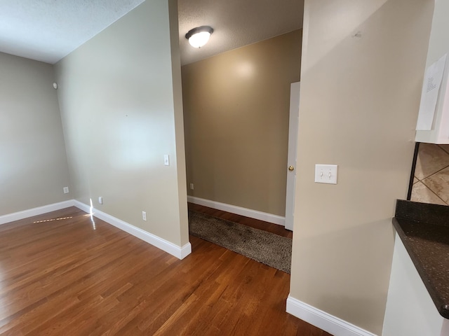 interior space with a textured ceiling and hardwood / wood-style flooring