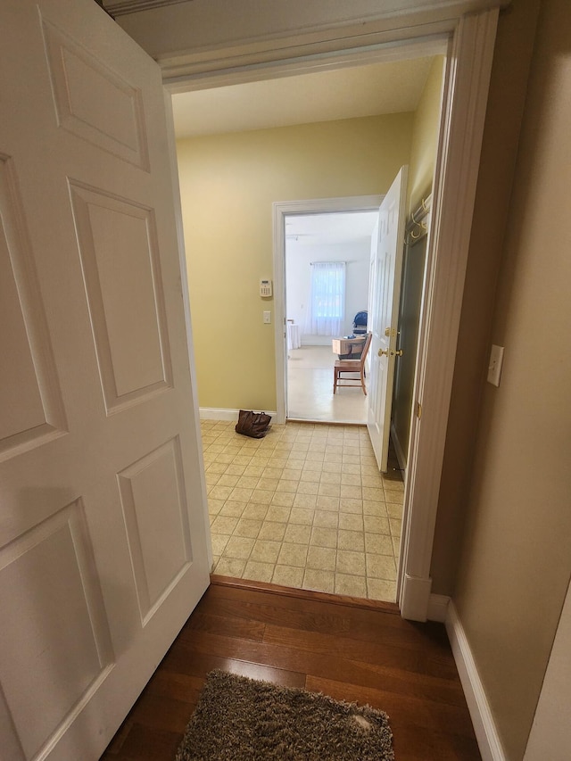 corridor with hardwood / wood-style floors