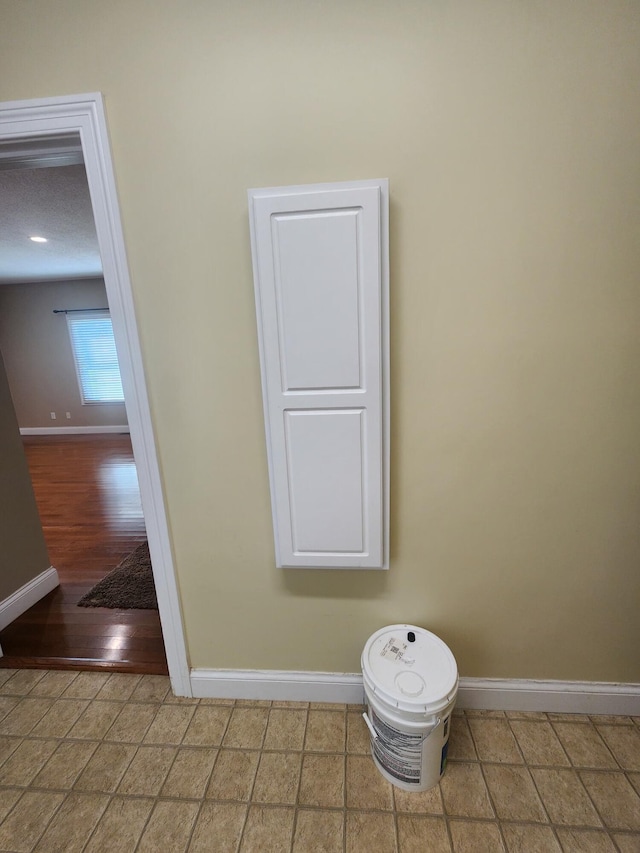 bathroom featuring a textured ceiling, toilet, and hardwood / wood-style flooring