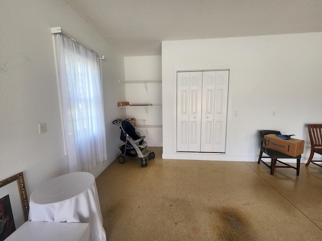 bedroom with a closet and a textured ceiling