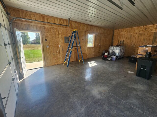 garage featuring wooden walls and electric panel