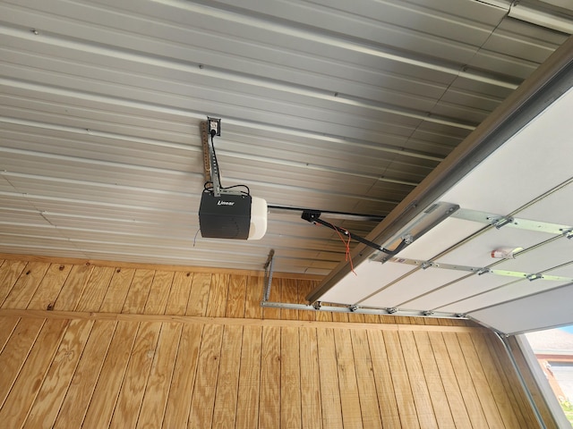 room details featuring a garage door opener and wood walls