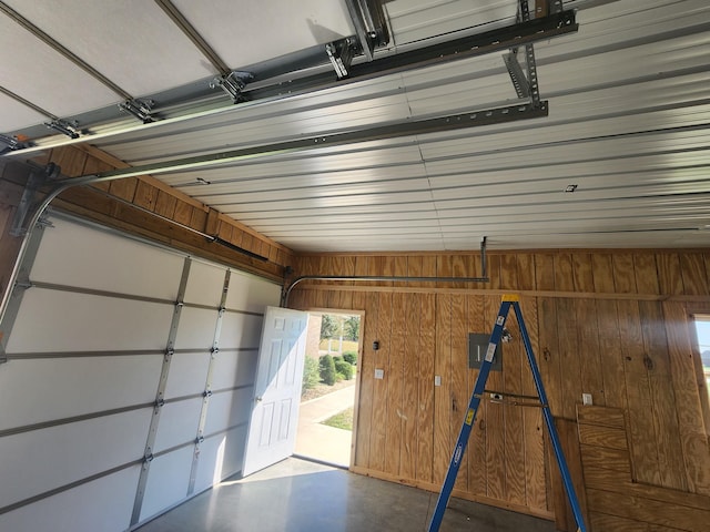 garage featuring wood walls