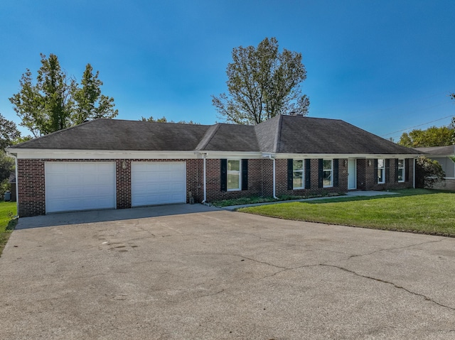 single story home with a garage, driveway, a front lawn, and brick siding