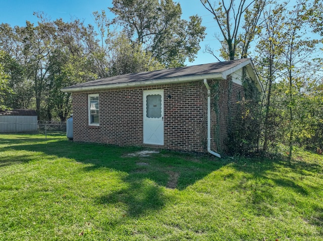 view of outbuilding featuring fence and an outdoor structure