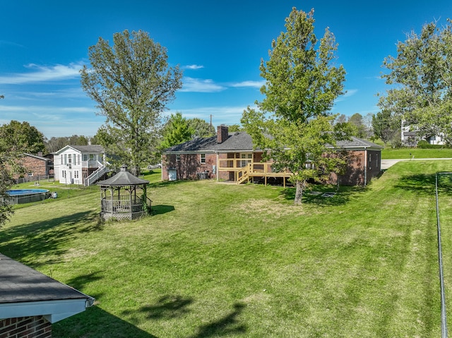 view of yard featuring a deck and a gazebo