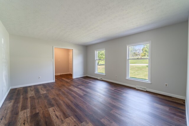 entryway with dark hardwood / wood-style flooring and a textured ceiling