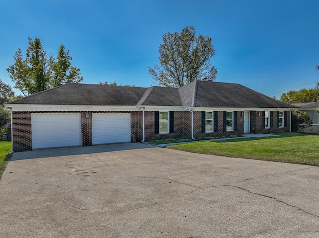 ranch-style house featuring a garage and a front yard