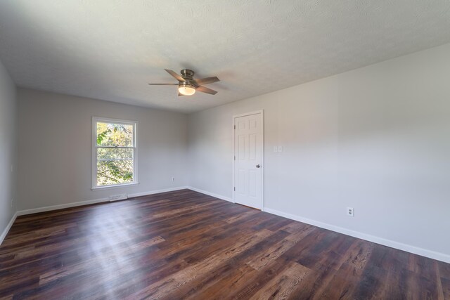 unfurnished living room with ceiling fan, a textured ceiling, and dark wood-type flooring