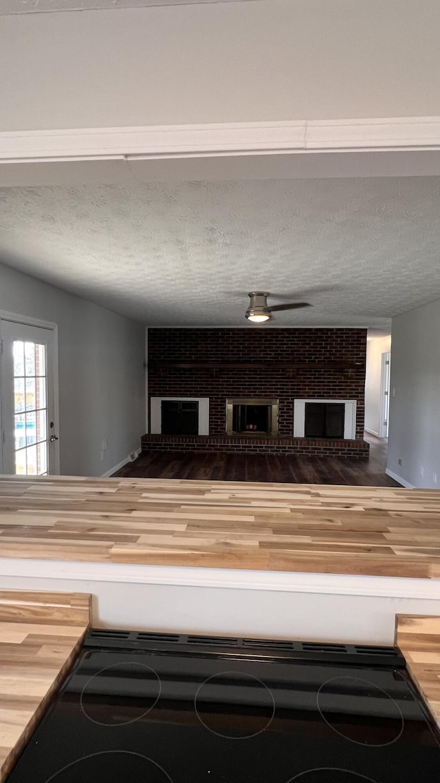 interior details featuring a fireplace and a textured ceiling