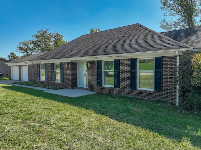 ranch-style house with a front yard and a garage