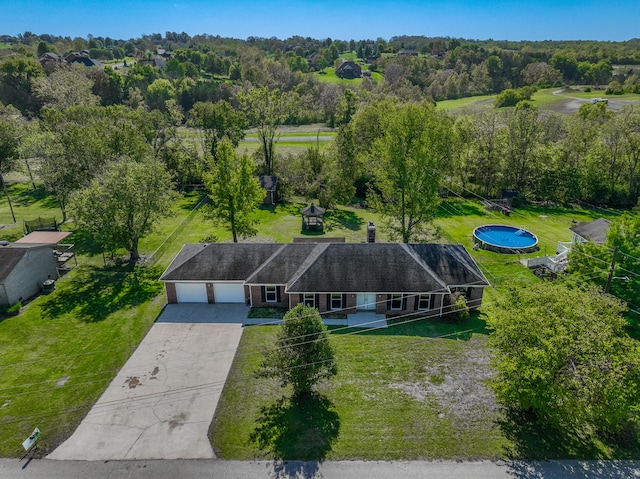 drone / aerial view with a wooded view