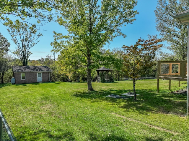 view of yard with fence and an outdoor structure