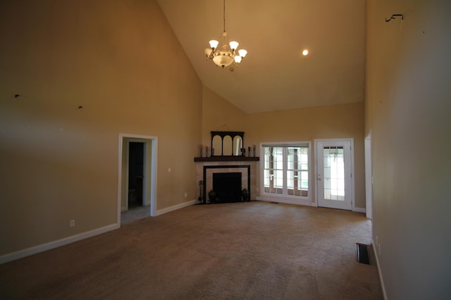 unfurnished living room with high vaulted ceiling, a notable chandelier, a tile fireplace, and carpet floors