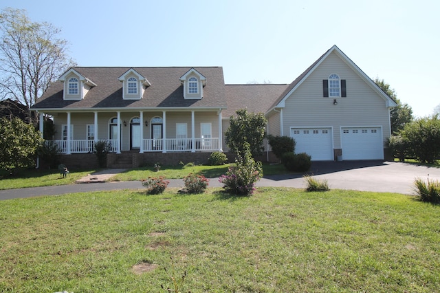 cape cod-style house featuring a garage, a front lawn, and covered porch