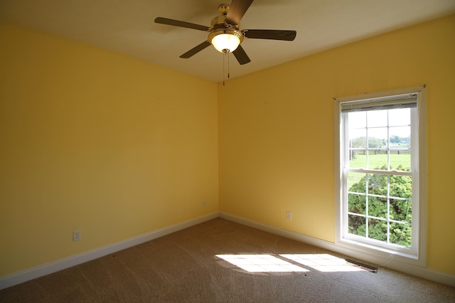 carpeted spare room with ceiling fan