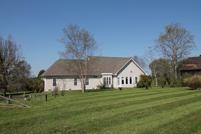 rear view of house featuring a yard