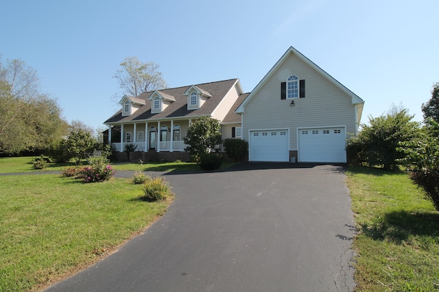 cape cod house with a garage, a front lawn, and covered porch