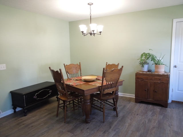 dining space with dark wood-style floors, baseboards, and a notable chandelier